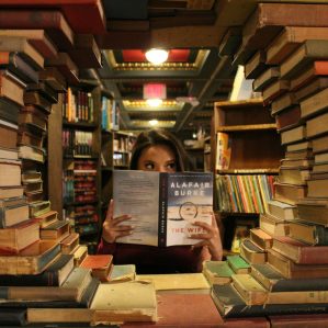 woman holding a book in a library