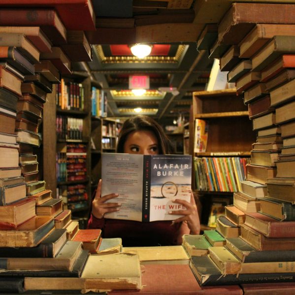 woman holding a book in a library