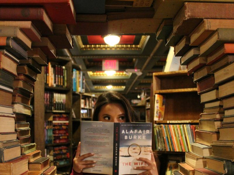 woman holding a book in a library