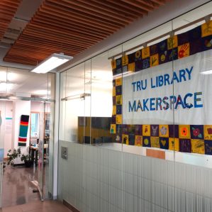 TRU Library Makerspace banner hanging in the entrance to the right of Tim Hortons.